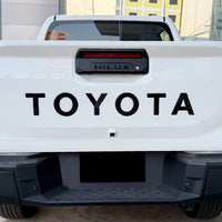 TOYOTA HILUX 2026 TAILGATE LOGO ABS MATT BLACK/GLOSS BLACK/WHITE/RED